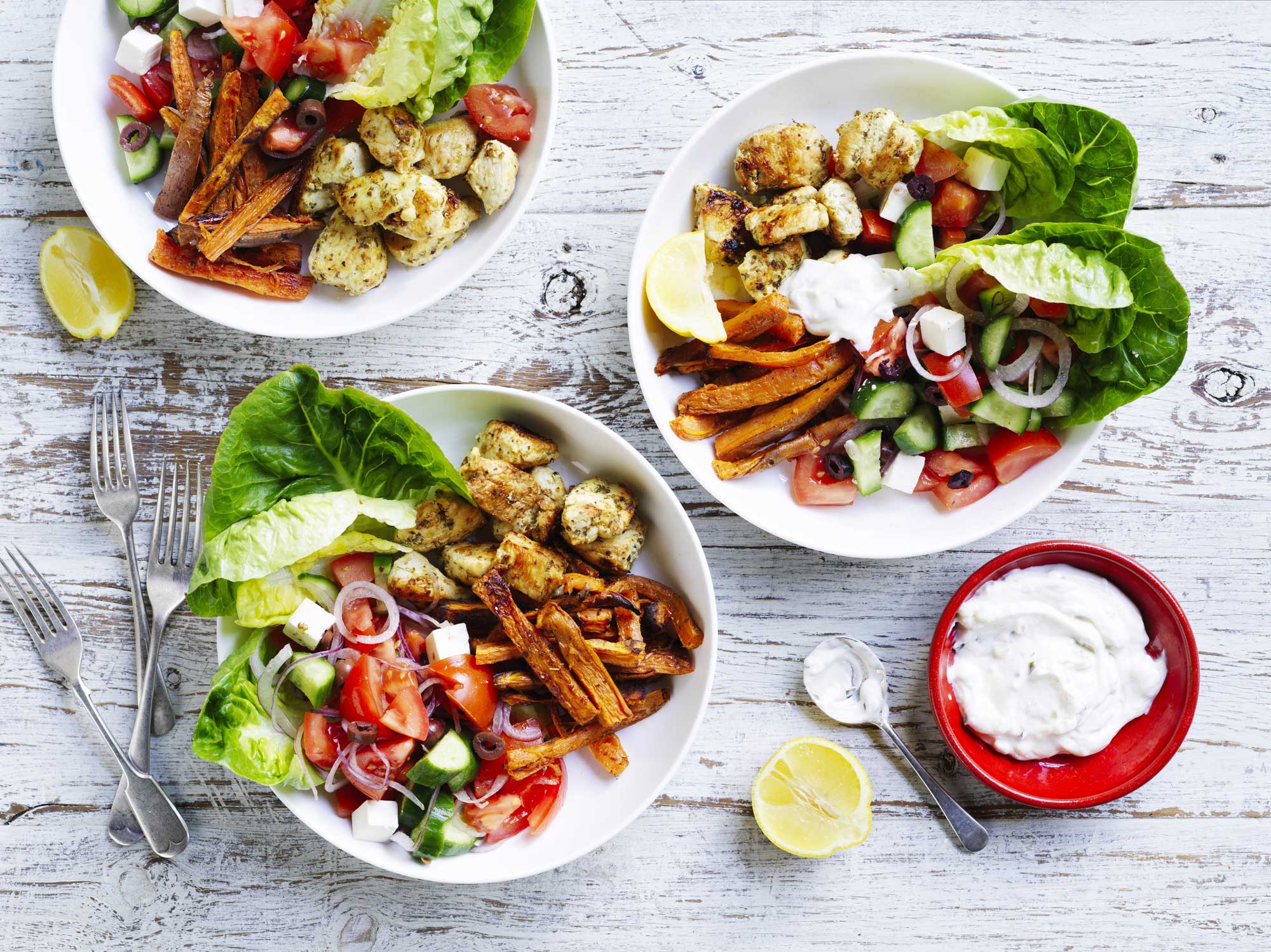 A colourful assortment of chicken and salad bowls
