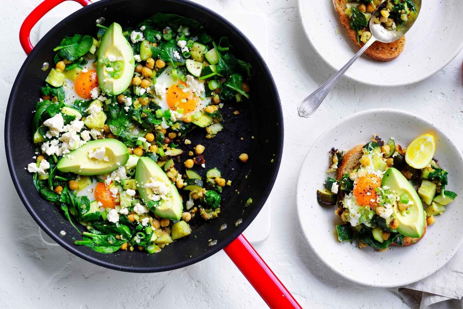 Green shakshuka completed meal served in dishes