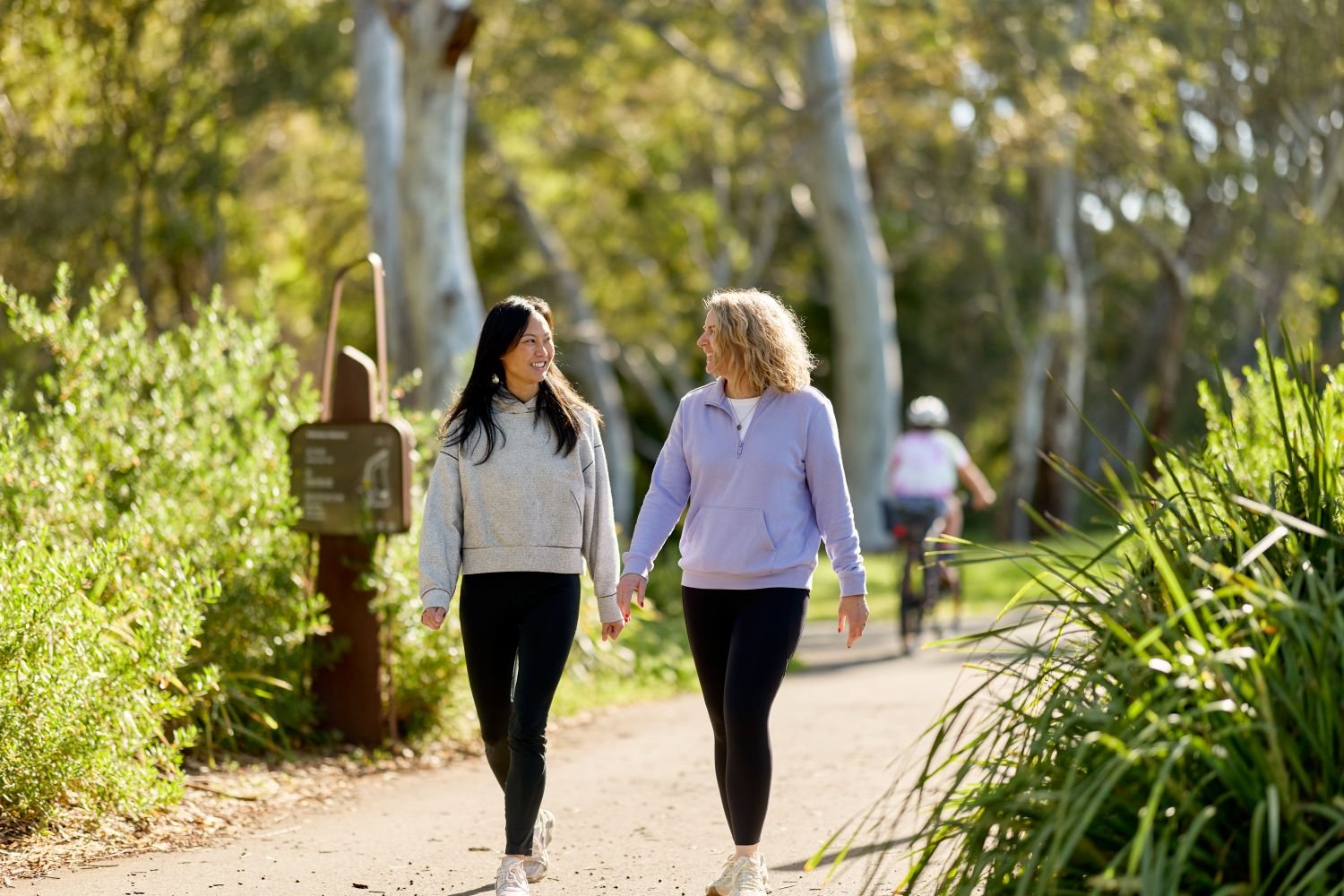 Two people walking along a bushland path, promoting an active lifestyle and heart health.