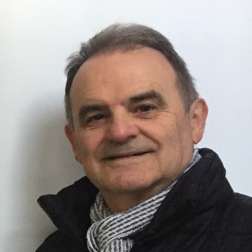 Murray Cheney, a heart surgery survivor, stands in front of his artwork at an exhibition