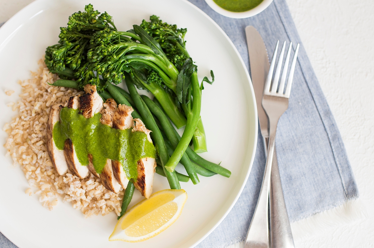 A plate of food featuring a savory combination of chicken, rice, and broccoli