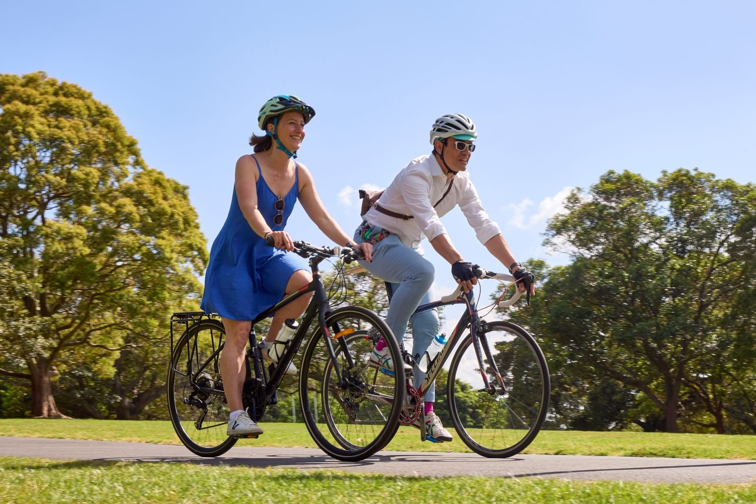 Two people cycling along a path
