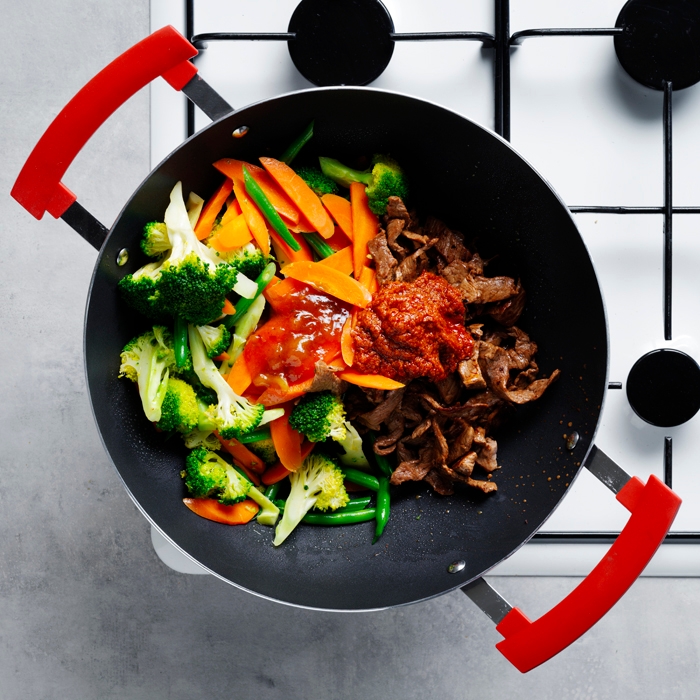 Vegetables in a wok with beef and massaman paste