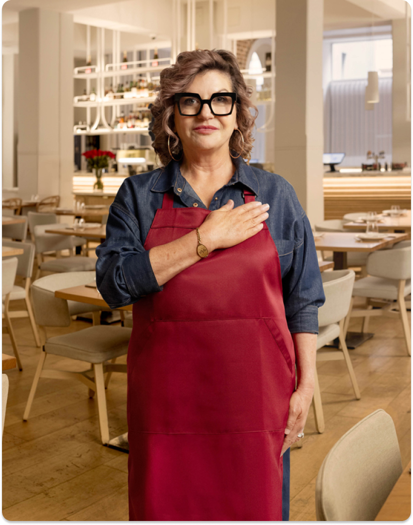 Mandy Hall hand on heart in a restaurant
