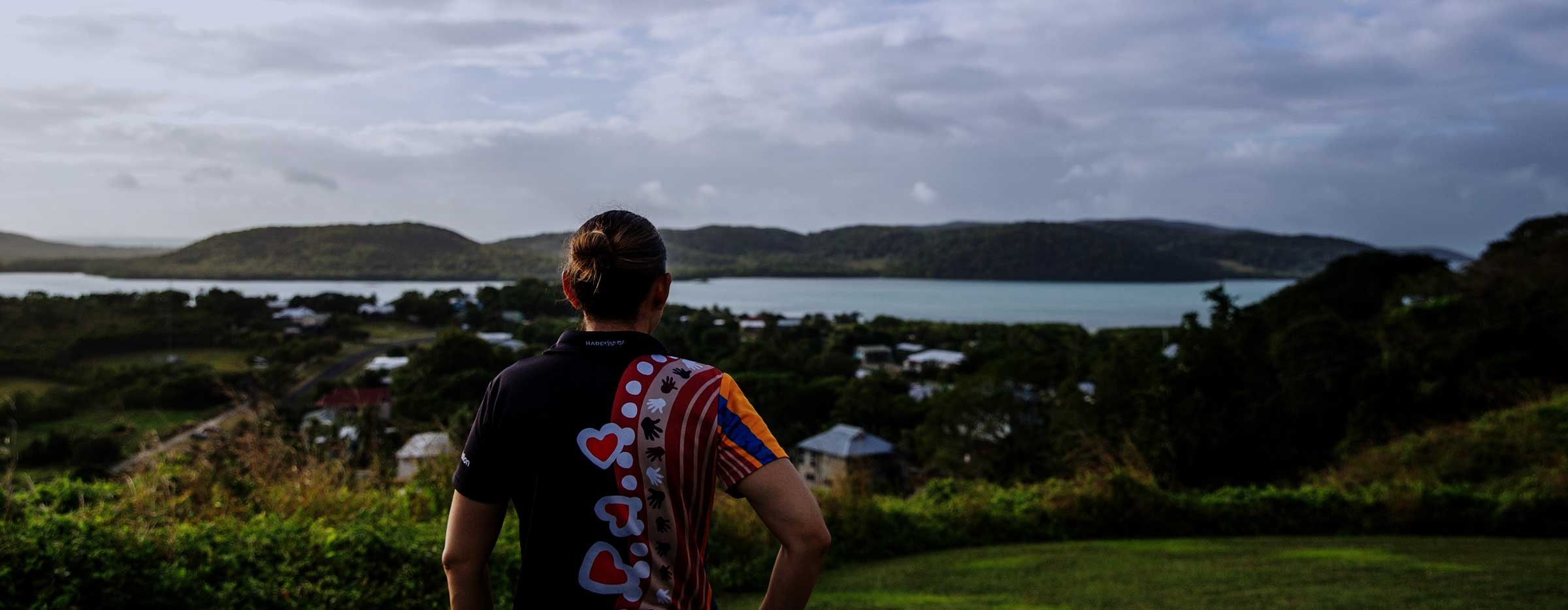 Young First Nations woman looking out over landscape