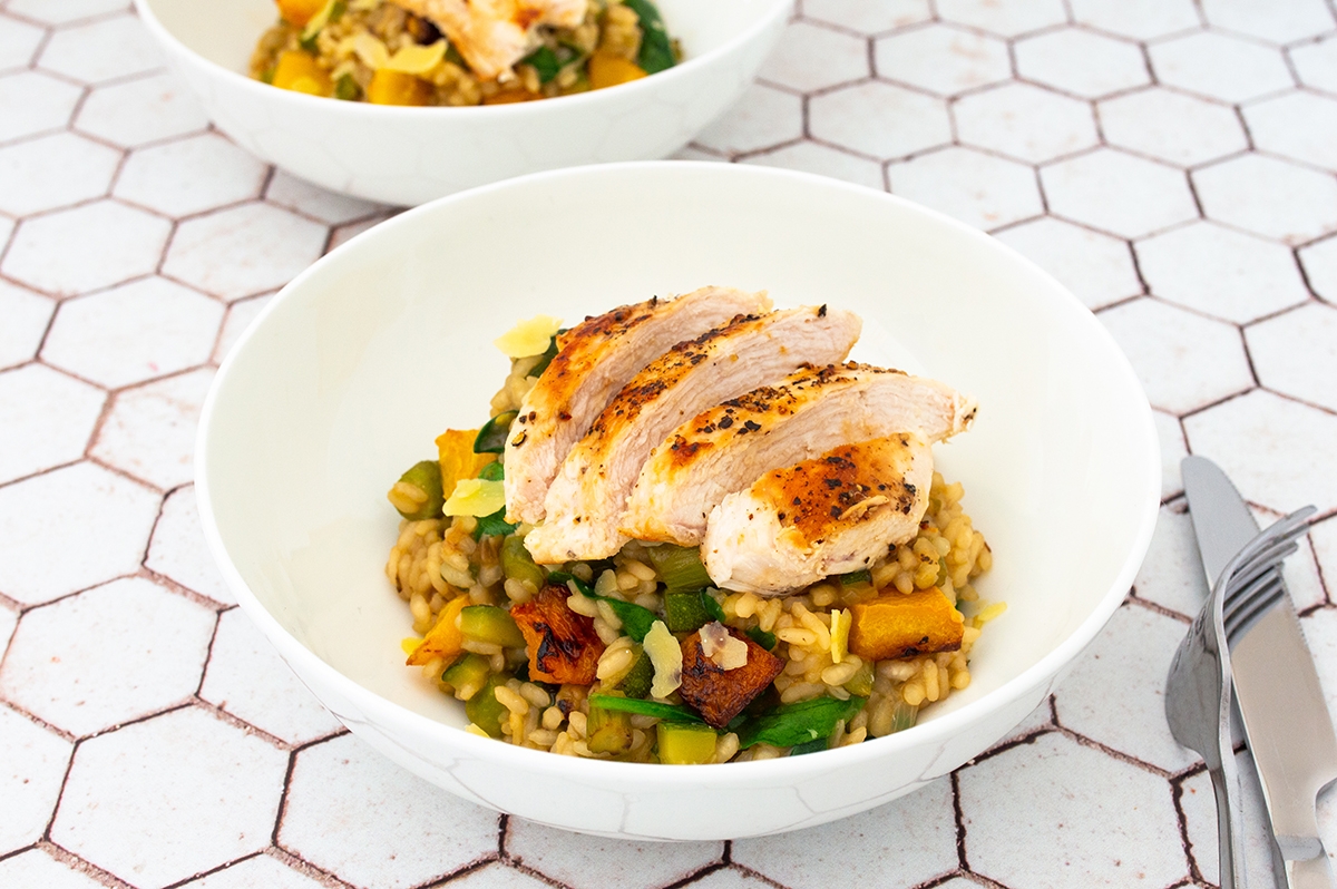 Two bowls of chicken and vegetable risotto 
