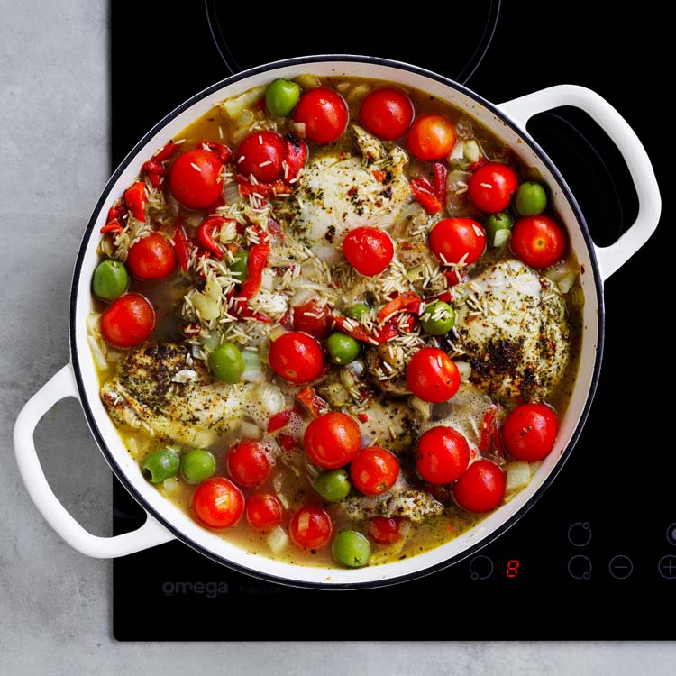 Chicken nestled back into the rice mixture with boiling water