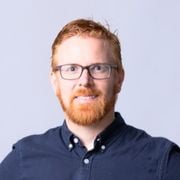 Profile Image Associate Professor Simon Foster wearing blue shirt and glasses