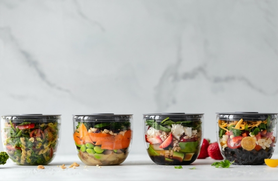 four glass containers containing food