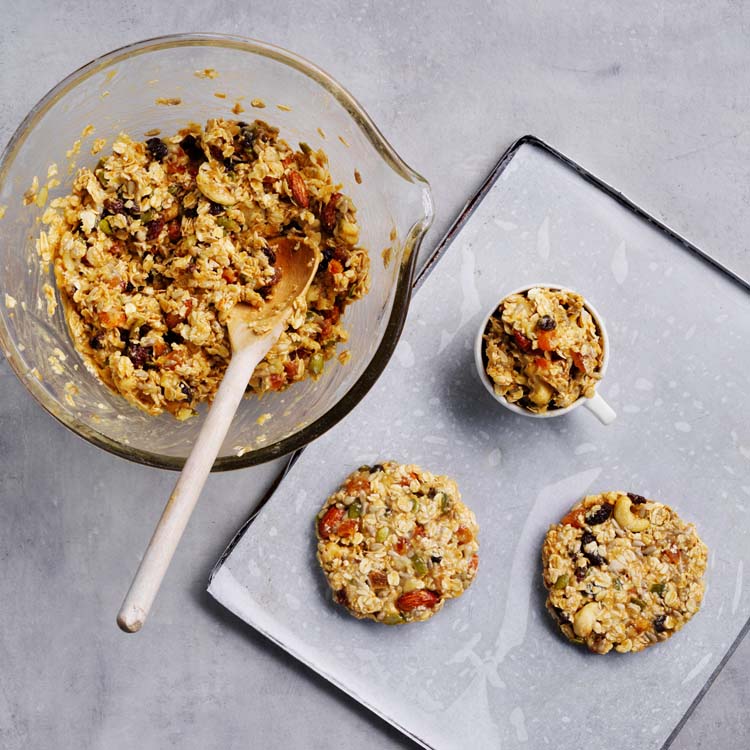 Cookie mixture spooned onto baking paper-lined trays