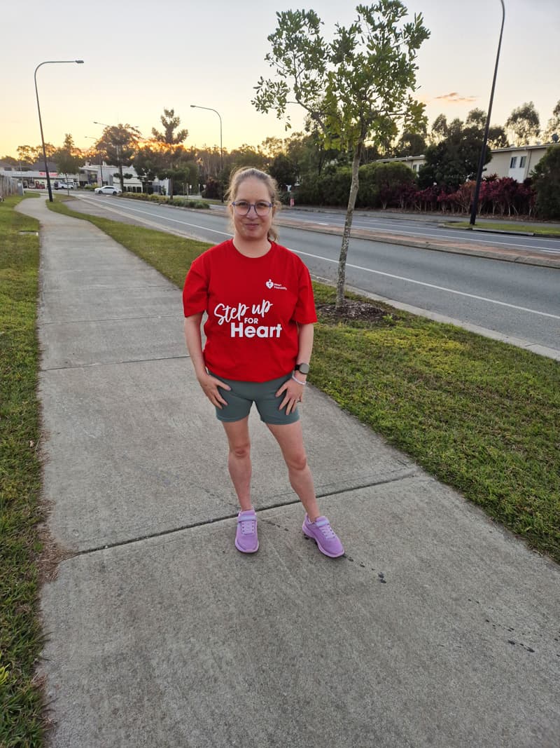 Taiya standing on footpath of a suburban street wearing a 'Step up for Heart' red t-shirt