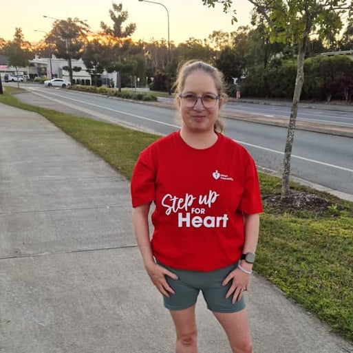 Taiya standing on footpath of a suburban street wearing a 'Step up for Heart' red t-shirt