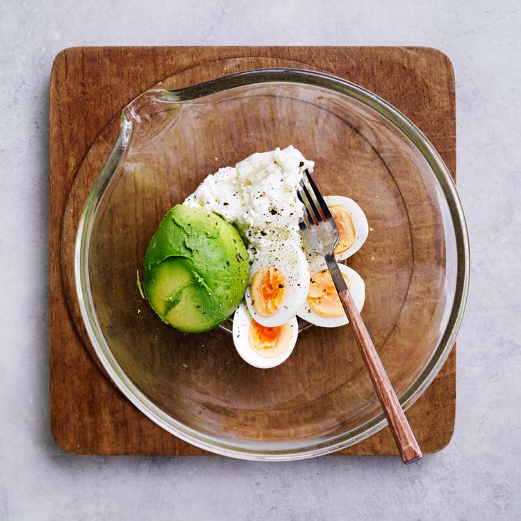 Eggs, avocado and cottage cheese coarsely mashed in a bowl