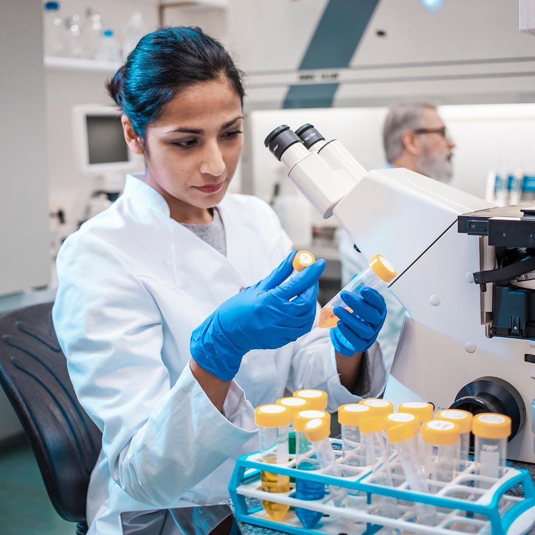 Female researcher looking at samples in a lab