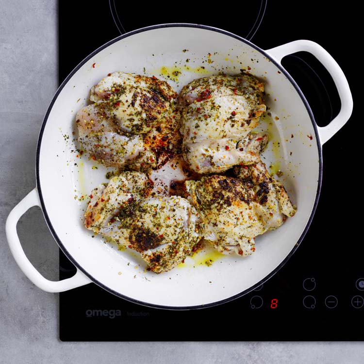 Chicken browning in a flameproof ovenproof dish
