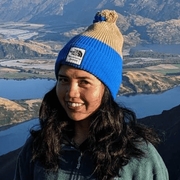Mae, a heart disease advocate, smiles after a hike in the mountains. She was diagnosed with ARVC and now volunteers to support heart disease research and awareness.