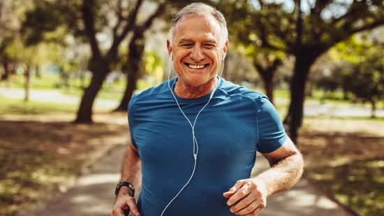 Elderly man jogging with headphones on