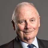 Garry Jennings in a suit and tie,smiles warmly