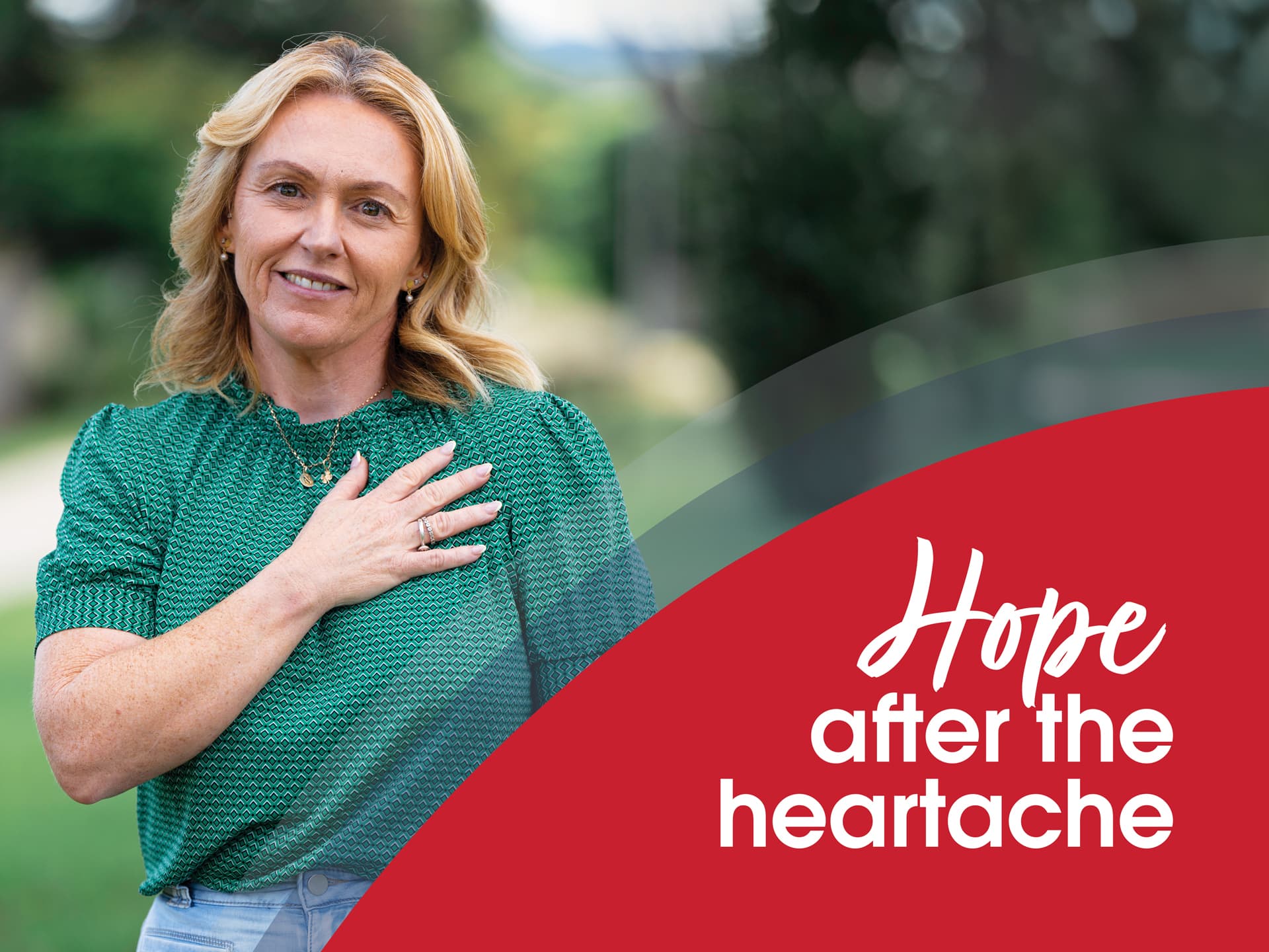 Heart attack survivor Nadene standing with hand on her heart