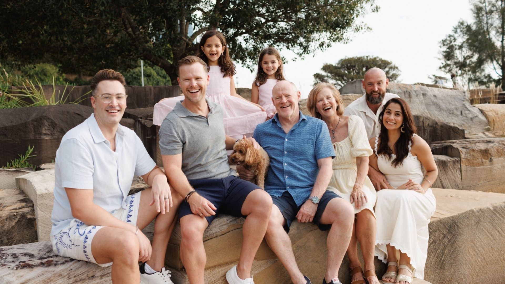 Our gift in Will supporter, Pam, and her intergenerational family sitting at the beach