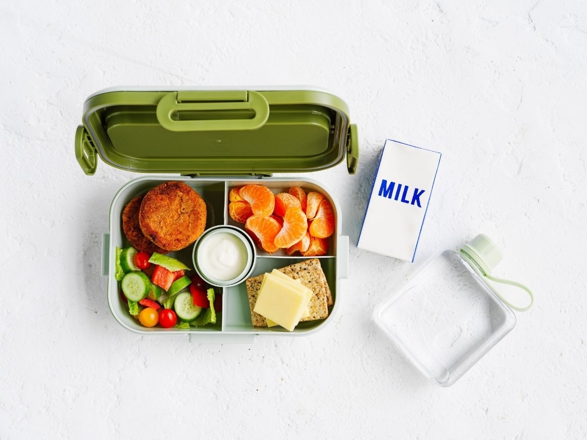 Salmon & sweet potato cakes, Green salad, Apple, Frozen milk popper, Wholegrain crackers, Sliced cheese, Water bottle