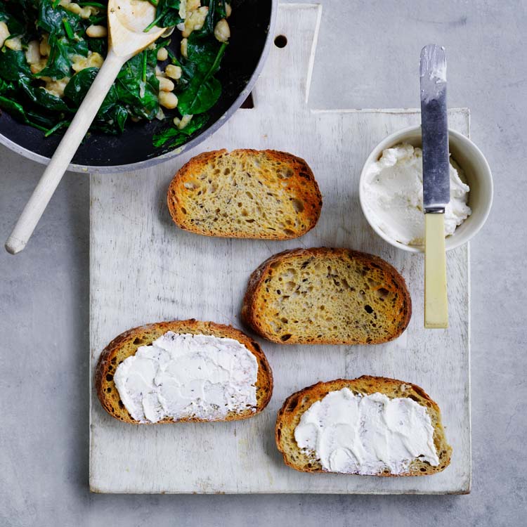 Toast spread with ricotta and topped with the bean mixture