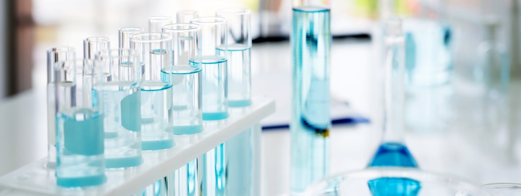 A laboratory with test tubes containing blue liquid, used for scientific experiments and research.
