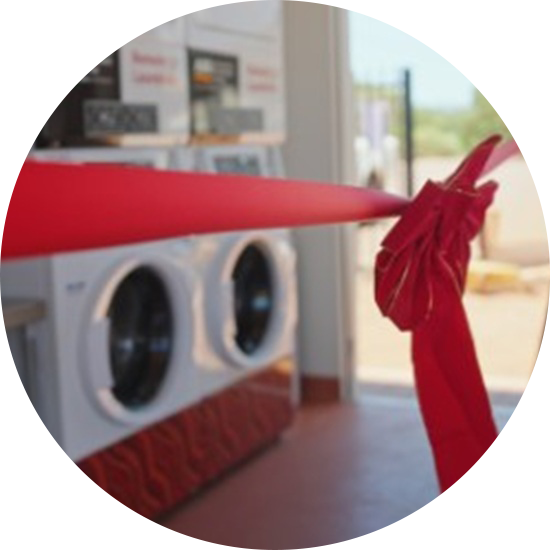 New AIG laundry clothes washing maching with opening launch red ribbon around them
