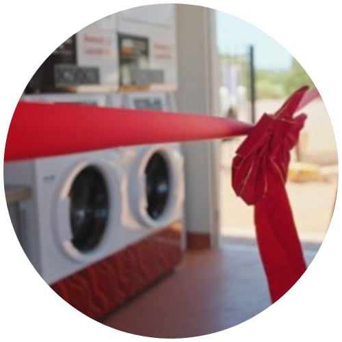 New AIG laundry clothes washing maching with opening launch red ribbon around them