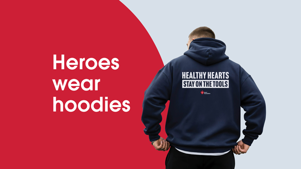 A man in a dark blue hoodie which says "Healthy hearts stay on the tools"