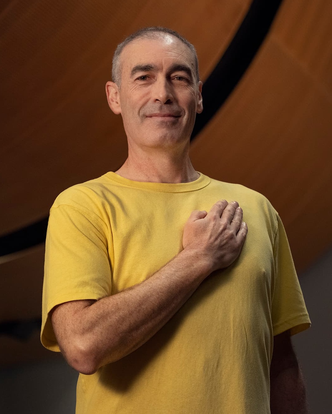 Greg Page, standing holding his heart on his heart