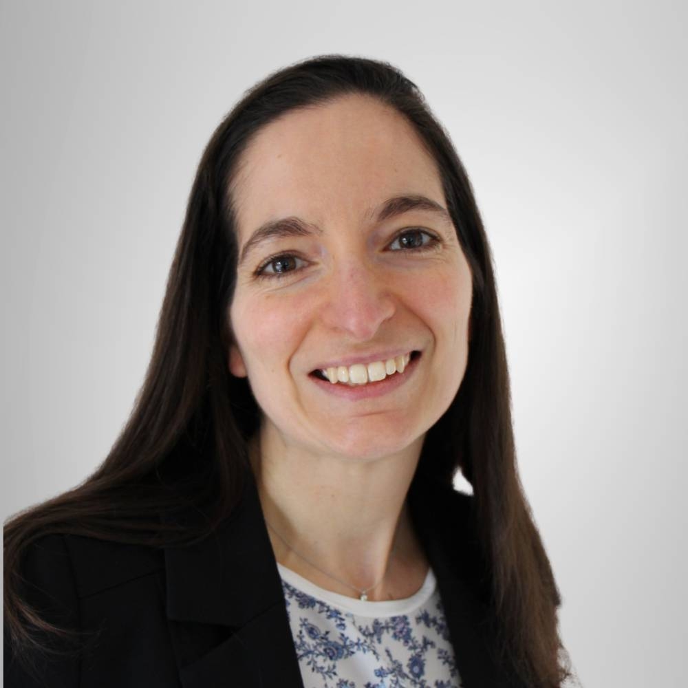 Virginie Lafougere, a woman wearing a blazer with a patterned shirt.