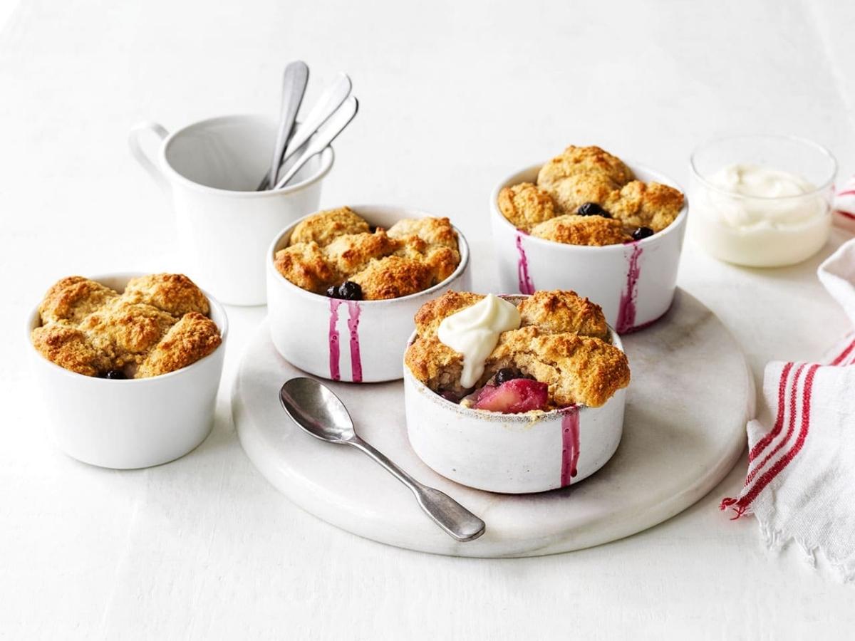 Pear and blueberry cobblers in small baking dishes