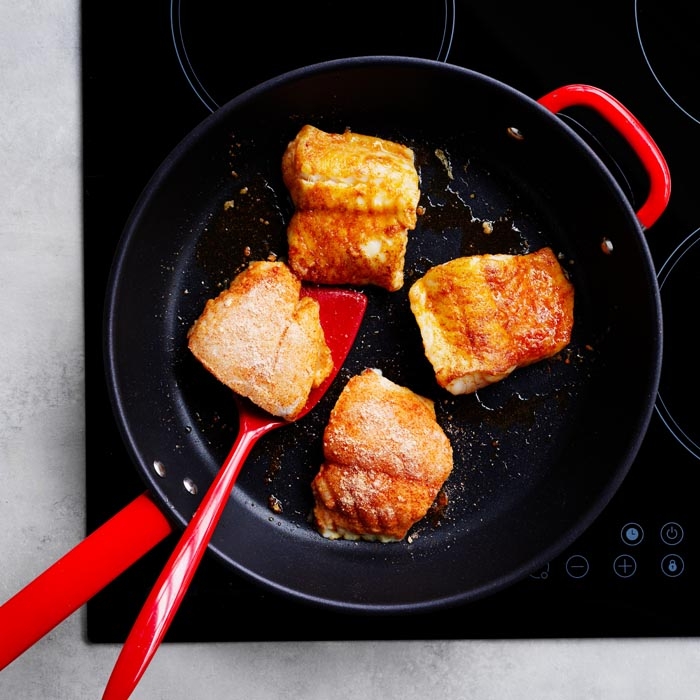 Cooking fish in a frying pan
