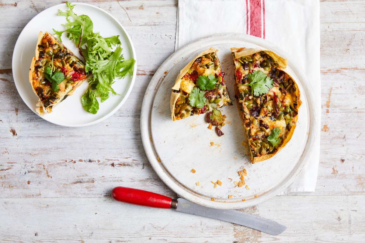 Mexican vegetable pie on a plate with a knife