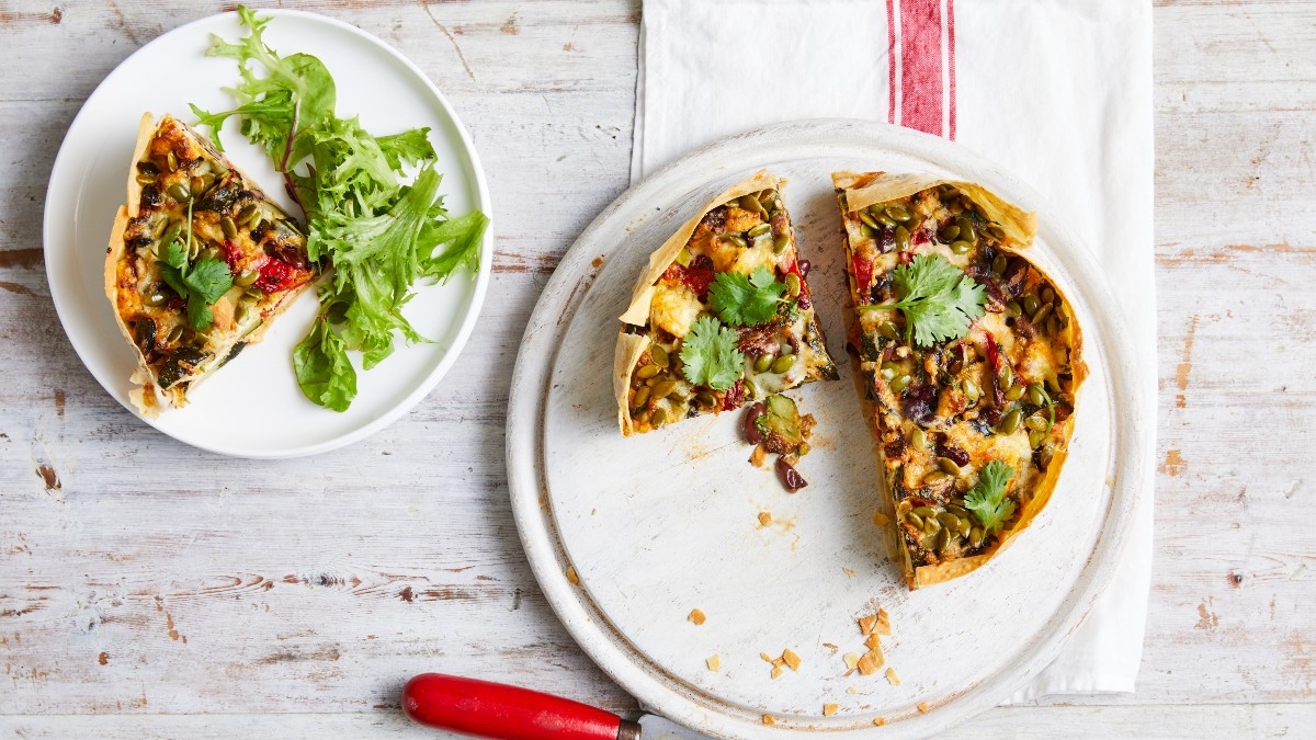 Mexican vegetable pie on a plate with a knife