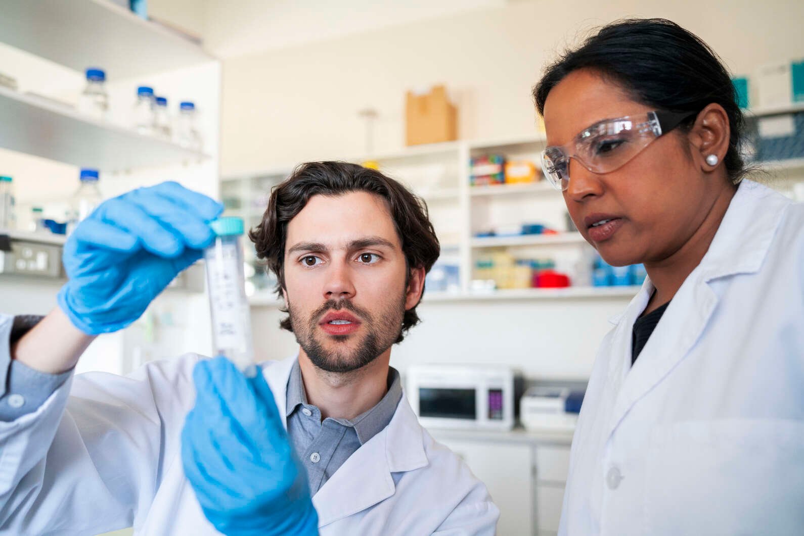 Researchers examining a laboratory sample as part of heart research