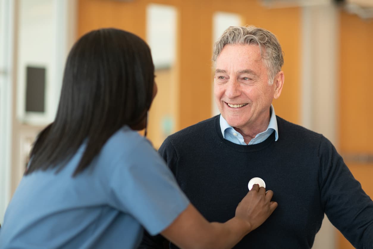 A nurse converses with a patient in a hospital, providing care and support.