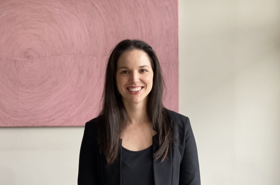 Doctor standing and smiling in black dress