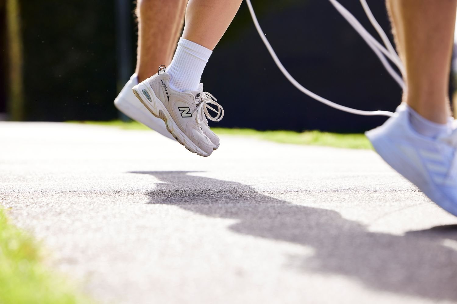 Close-up of a person skipping with a rope outdoors as part of an active lifestyle.
