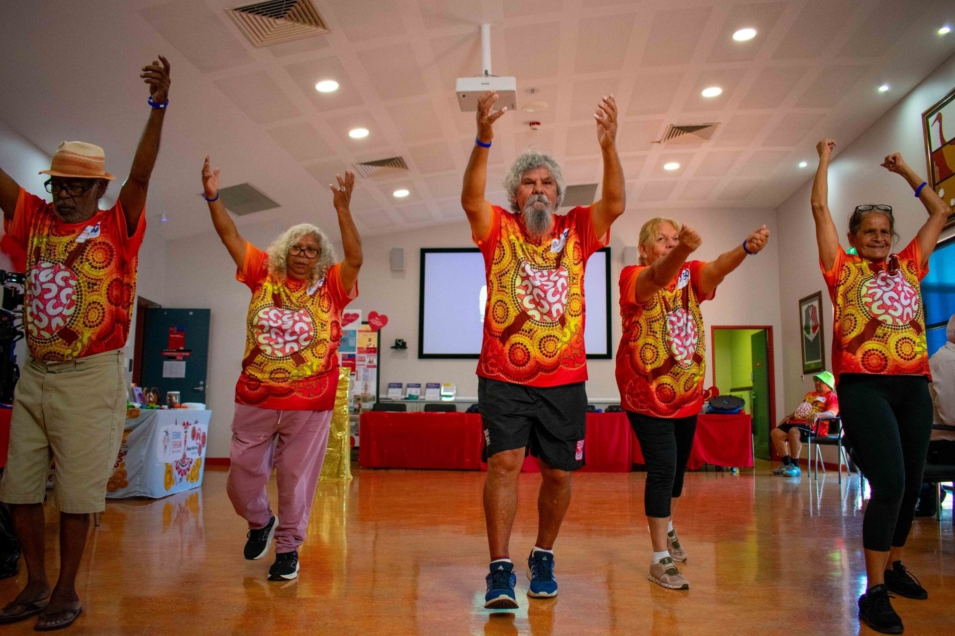 A group of older First Nations mena and women engaging in movement at the Derbarl Yerrigan Health Service