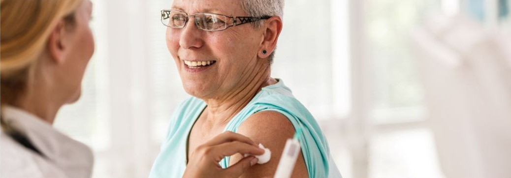 Healthcare professional administering a vaccination to a patient in a clinical setting