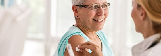 Healthcare professional administering a vaccination to a patient in a clinical setting