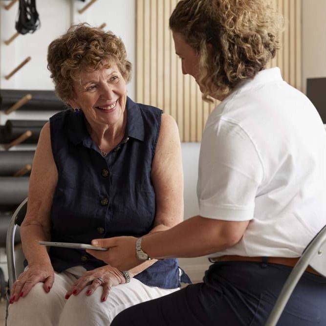 Health professional speaking with a community member during a consultation