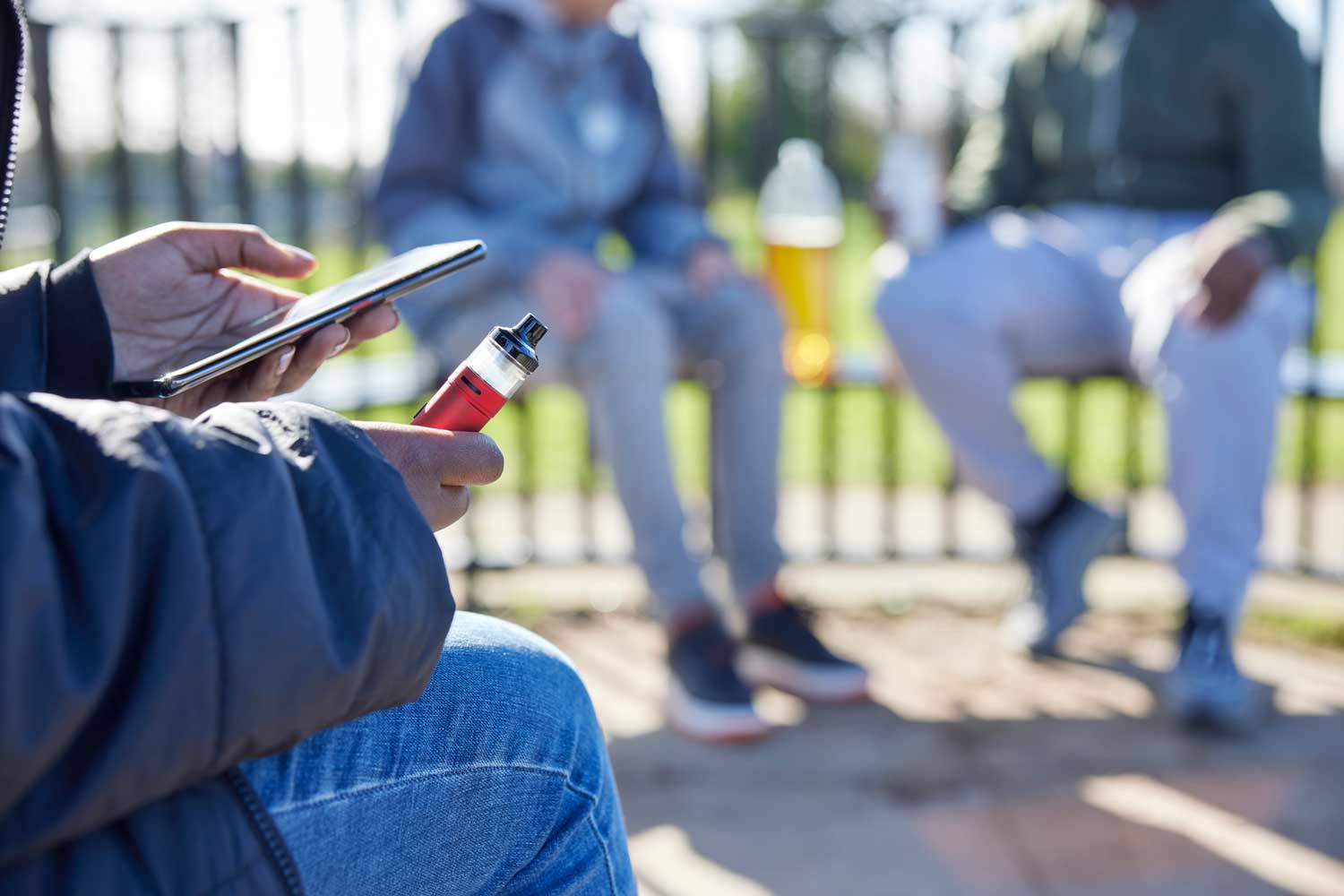 Teenagers vaping and drinking outdoors