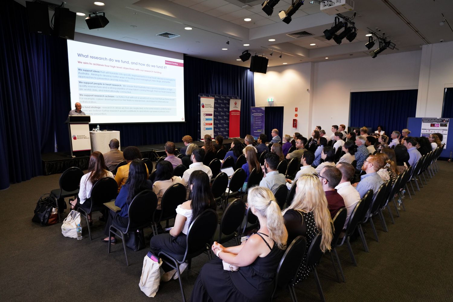 Audience seated at a conference listening to a presentation