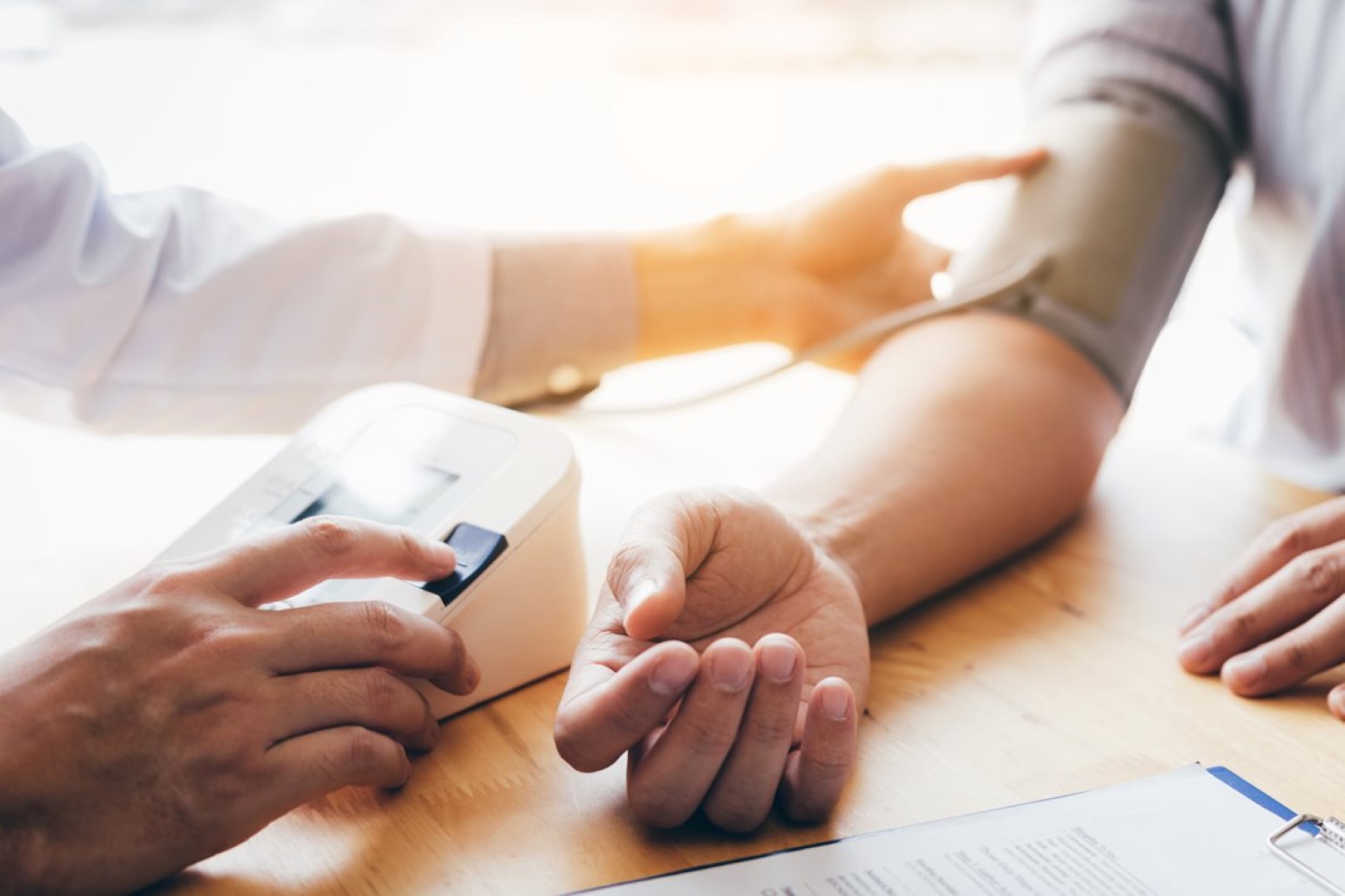 Doctor diagnosing patient with a blood pressure machine