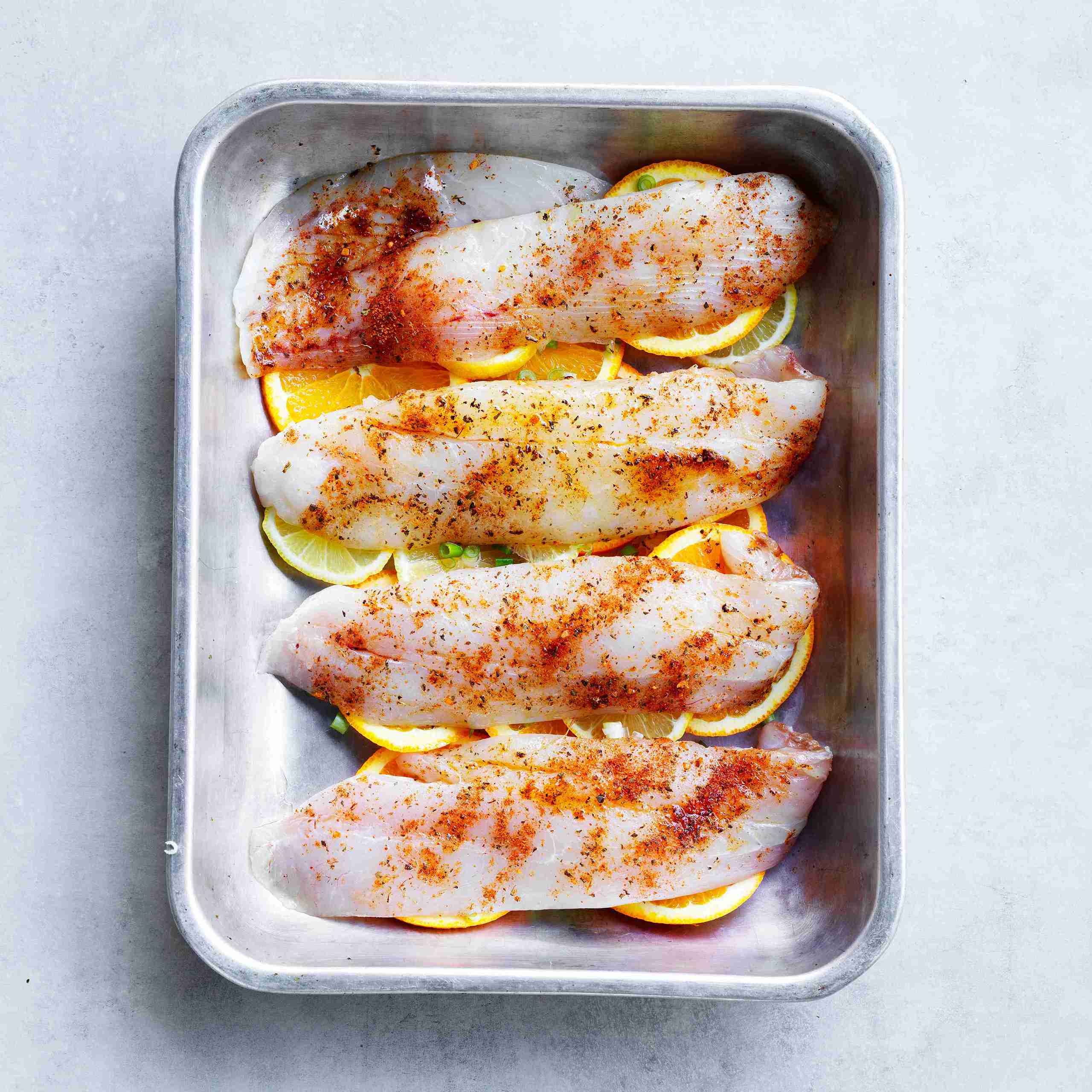 fish baking in oven; potatoes and beans cooking separately.