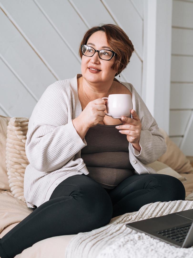 A woman holding a cup of tea