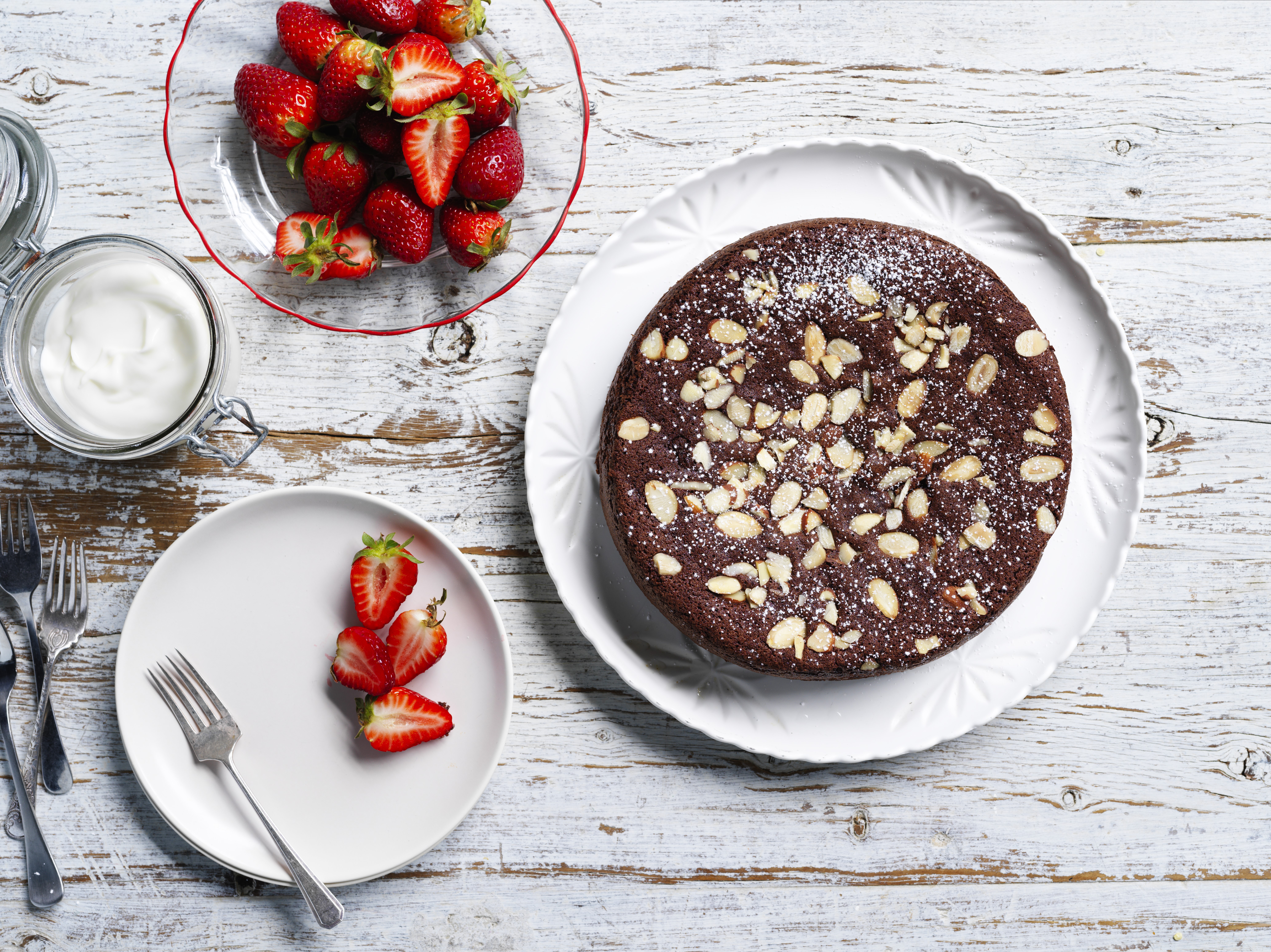 Chocolate cake and strawberries on a white table 